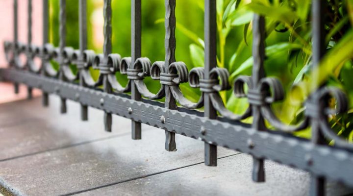 close up of a metal fence of a house with detailed design